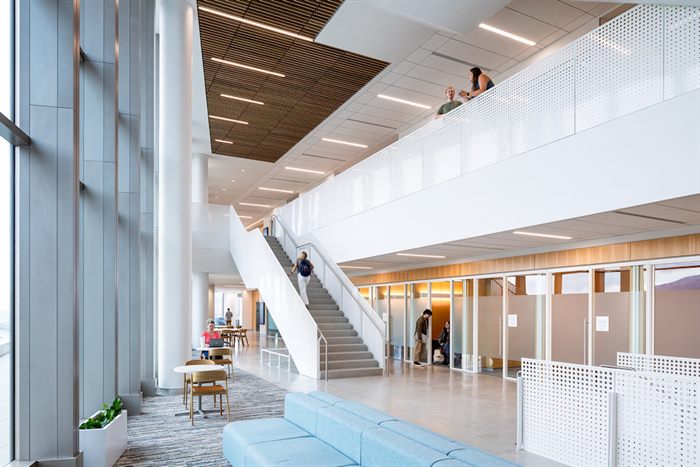 View from the upper-level walkway down into a shared lounge space