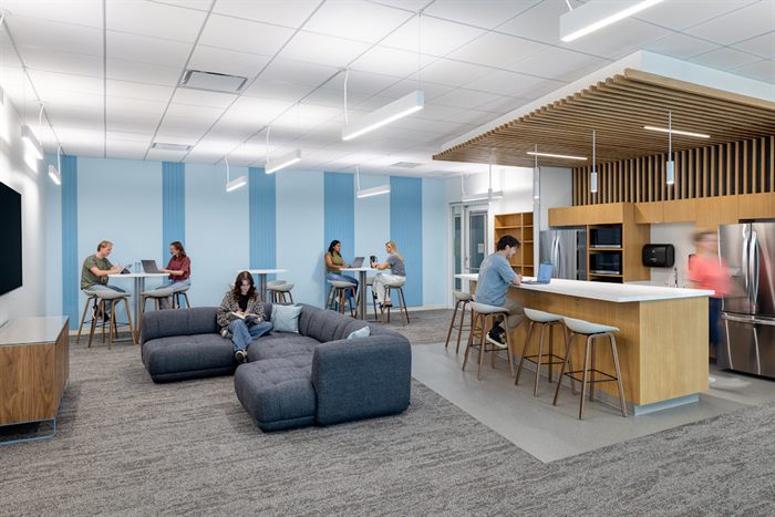 Student lounge and kitchen area with seating and study tables